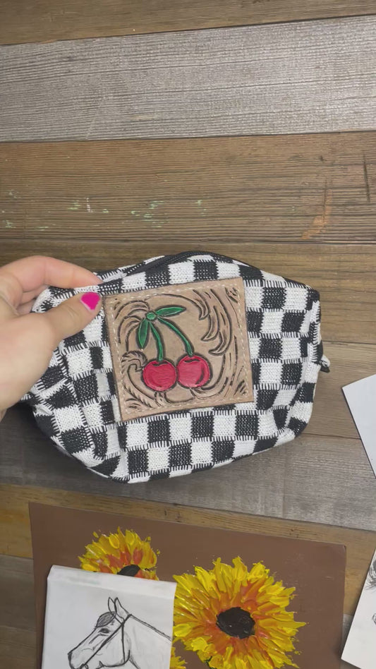 Checkered bag with tooled leather patch